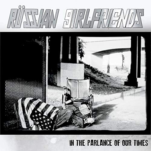 Vinyl album cover: black and white photo of a wheelchair and American flag.