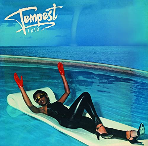 Album cover: woman in black by a pool, red gloves raised.