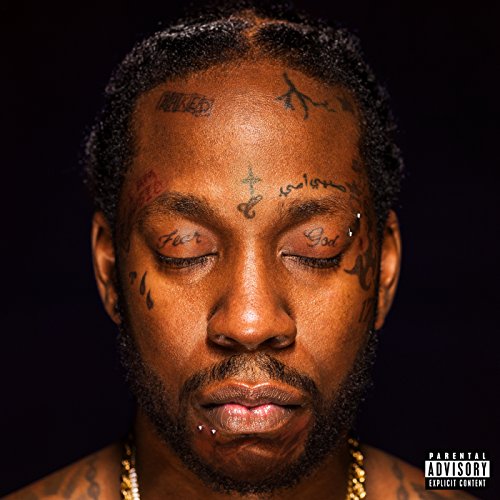 Close-up portrait of Two Chainz with face tattoos, eyes closed.