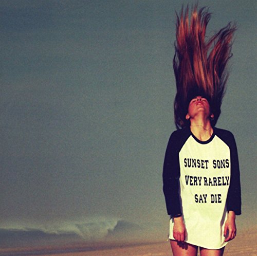 Person with windswept hair wearing a shirt with album title text.