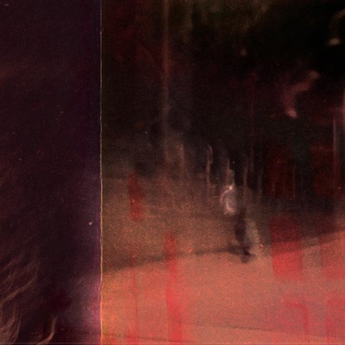 Dark, blurry image of a figure in a reddish, abstract landscape.