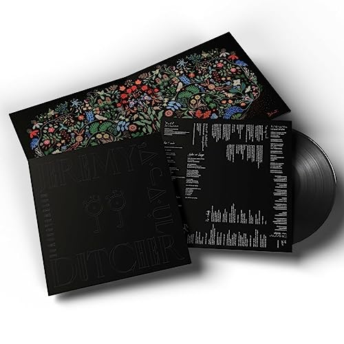 Black vinyl record with ornate floral cover and white text.