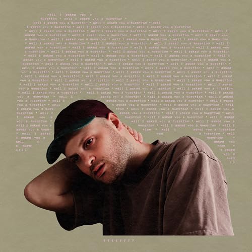Vinyl album cover featuring a man wearing a cap, overlaid with text.