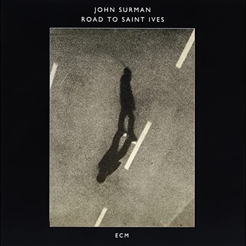 CD cover: shadow of a person walking on a road.