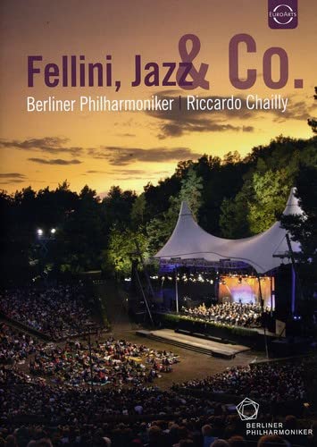 DVD cover: outdoor concert with orchestra, tents, and audience.