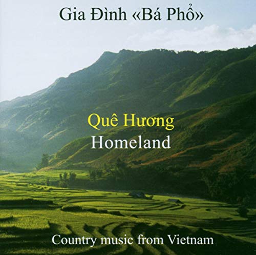 CD cover with misty mountains and green fields, titled “Que Huong (Homeland)”.