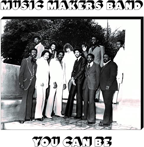 Black and white photo of Music Makers Band posing outdoors.