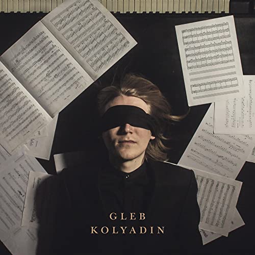 Blindfolded man surrounded by sheet music, album cover for Gleb Kolyadin.