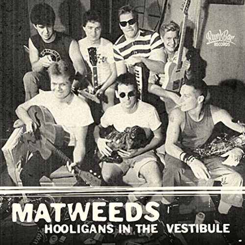 Black and white photo of six young men with instruments, album cover.