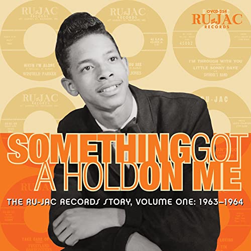 CD cover featuring a portrait of a man with vintage record labels.