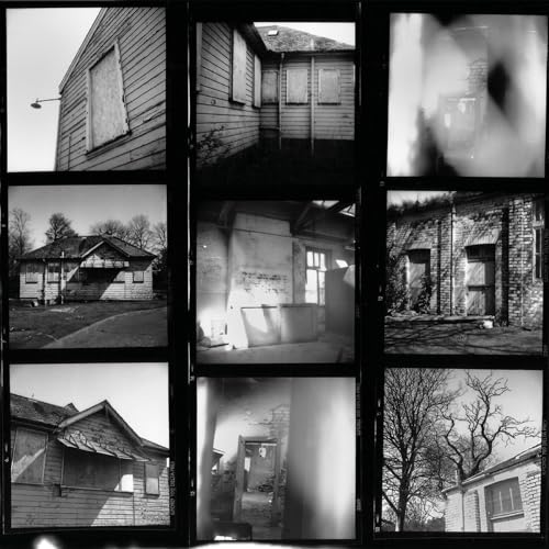 Black and white collage of weathered buildings and blurred windows.
