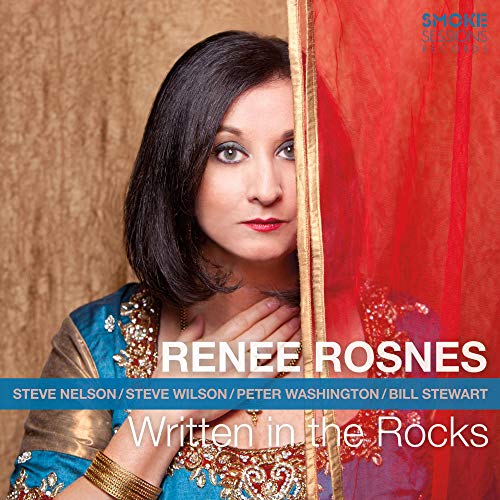 CD cover featuring Renee Rosnes, portrait with red fabric backdrop.