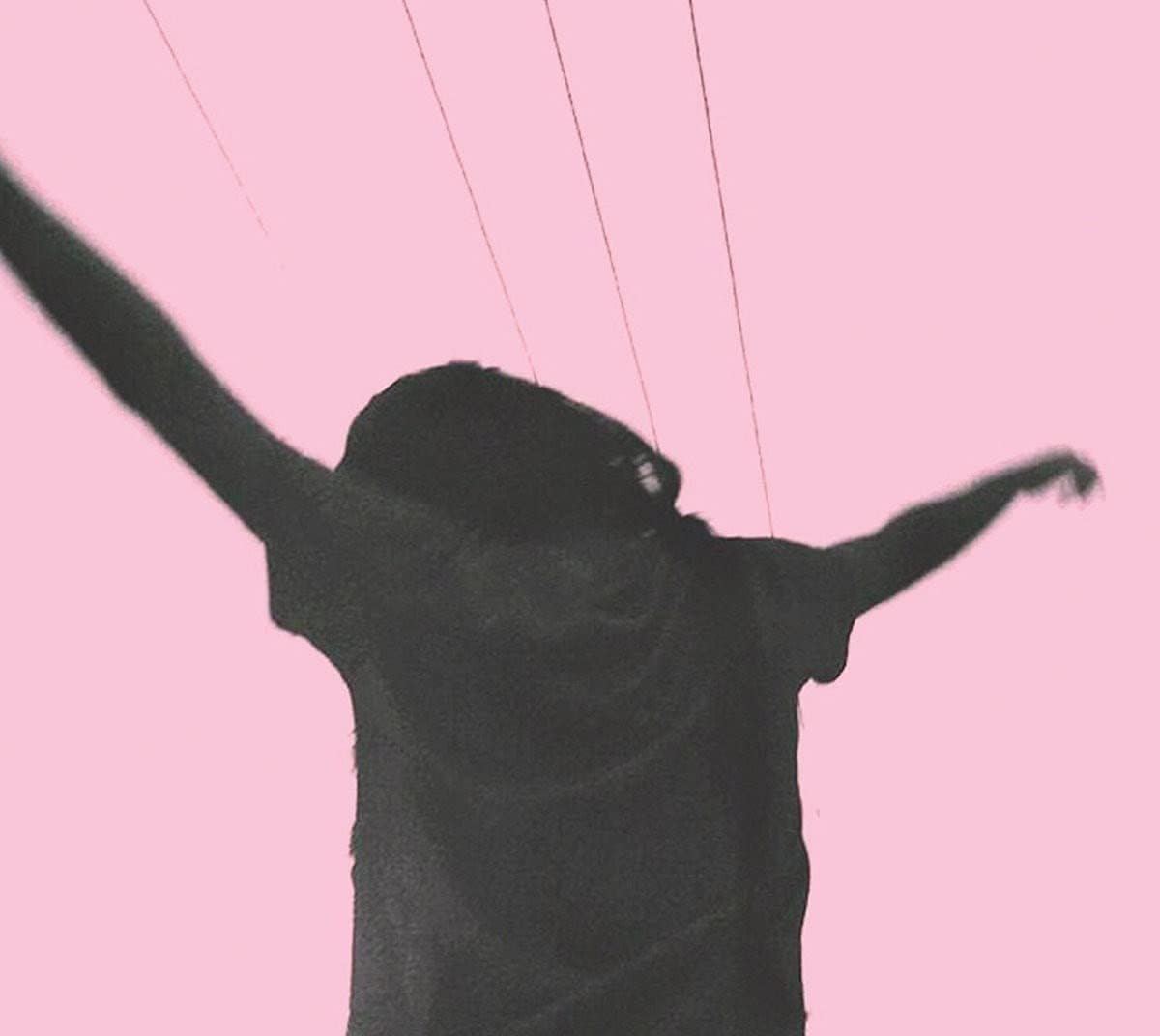 Silhouette of a person with arms raised against a pink background.