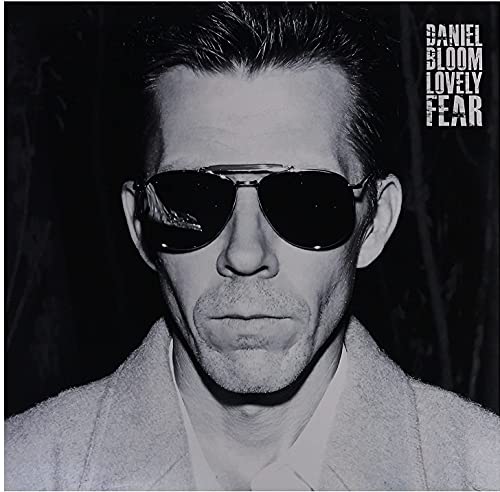 Black and white portrait of Daniel Bloom wearing sunglasses, album cover.