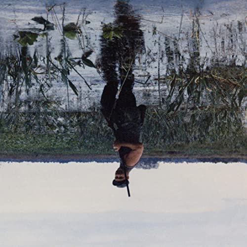 Album cover depicting a person submerged upside down in water.