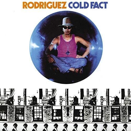 Rodriguez sits inside a blue sphere above a repeating black and white building pattern.