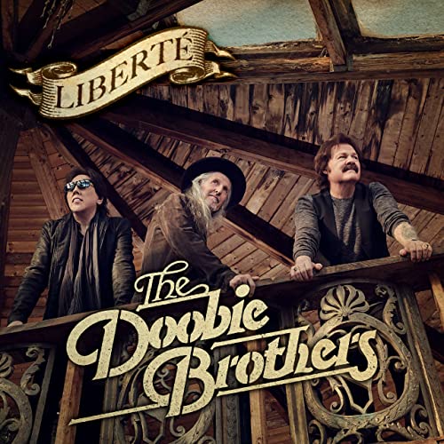 The Doobie Brothers album cover, three musicians on a wooden balcony.