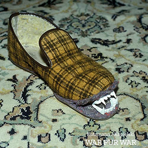 CD case with a plaid slipper featuring plastic vampire teeth attached.