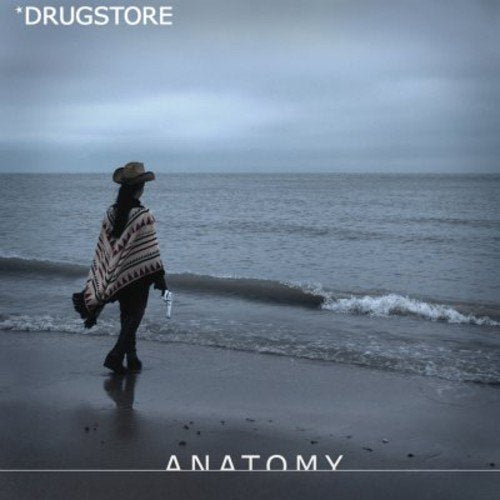 Person with a gun walks on a beach, album cover.