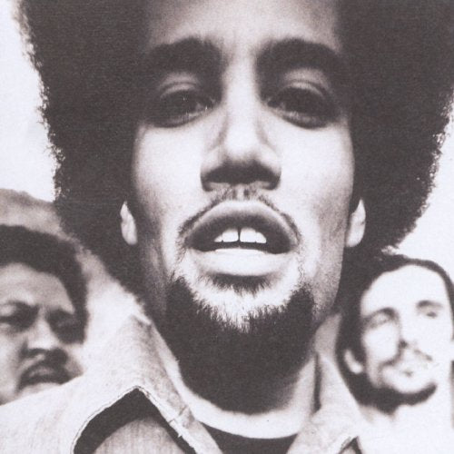 Close-up black and white portrait of Ben Harper with an afro.