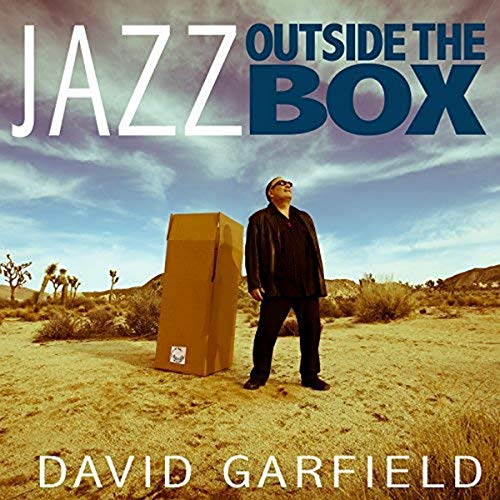 CD cover: Man with a cardboard box in a desert landscape.