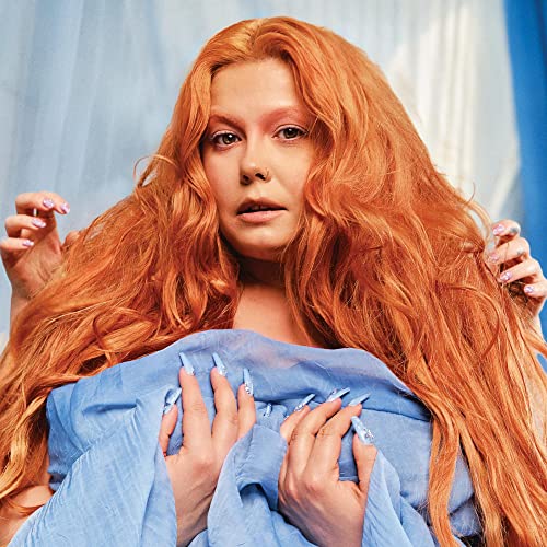 Woman with long red hair and blue clothing, album cover art.