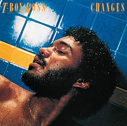 Close-up of T-Boy Ross with wet hair, lying in a blue-tiled space.