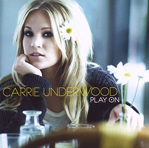 Carrie Underwood album cover, "Play On," featuring a blonde woman with daisies.