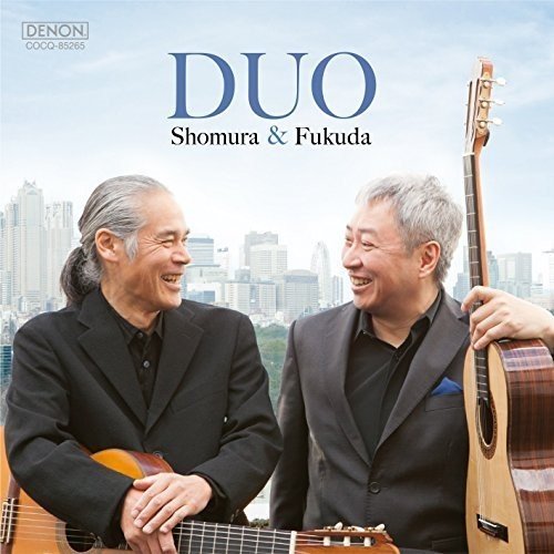 CD cover featuring two smiling men with guitars, city skyline backdrop.