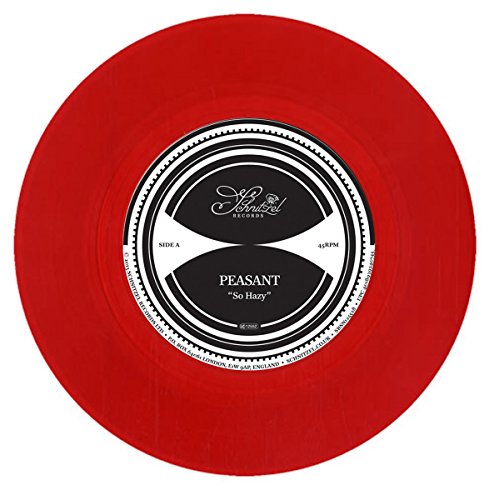 Red vinyl record with a white and black center label, displaying text.