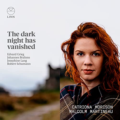 CD cover featuring red-haired woman and blurred landscape background.