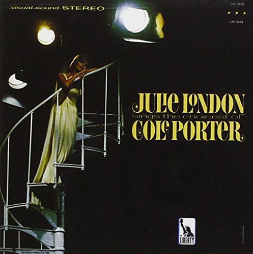 Julie London album cover, woman on spiral staircase, dark background.