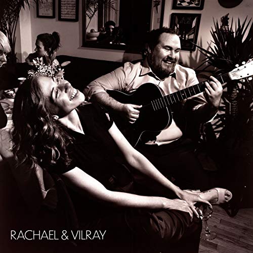 Black and white album cover featuring a man playing guitar and a woman singing.