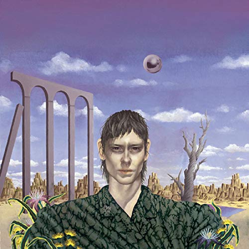 Album cover: portrait of a man in a surreal, desert landscape.