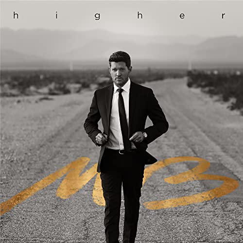 Michael Bublé in suit stands on a desert road, album cover.