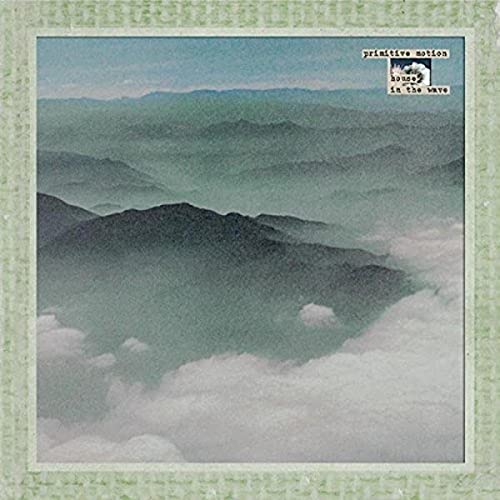 Green and gray layered mountains with white clouds, album cover art.