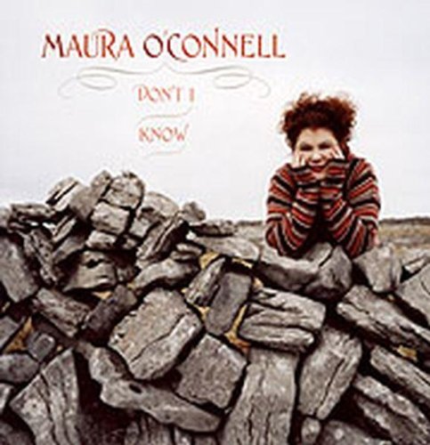 CD cover: Maura O'Connell sits on a stone wall, smiling.