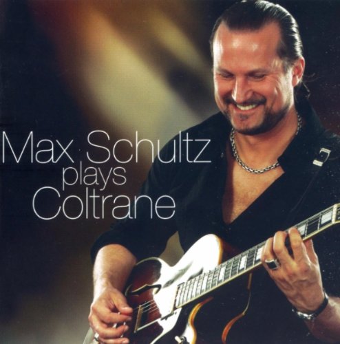 Max Schultz smiling while playing a sunburst-finish guitar.