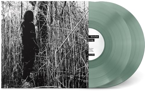 Vinyl record with green tint and album cover featuring a person in tall grass.
