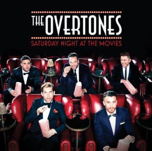 The Overtones band members in tuxedos sitting in a cinema holding popcorn buckets.