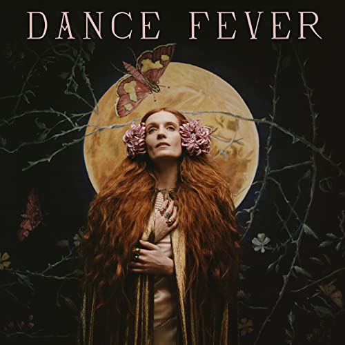Florence Welch with flowers in her hair, against a golden moon.