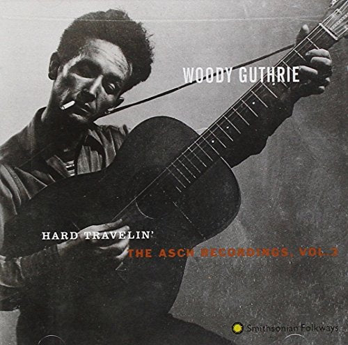 Woody Guthrie playing guitar on the cover of “Hard Travelin’” CD.