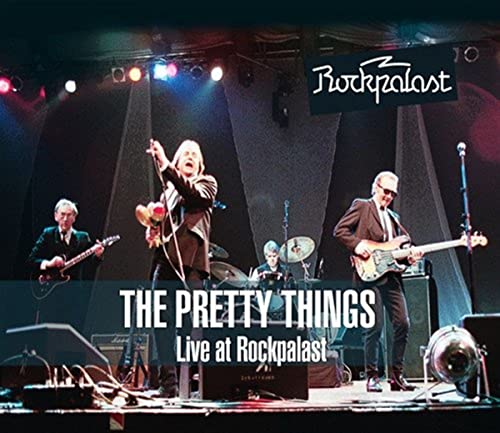 The Pretty Things band performing live on stage with bright lights.