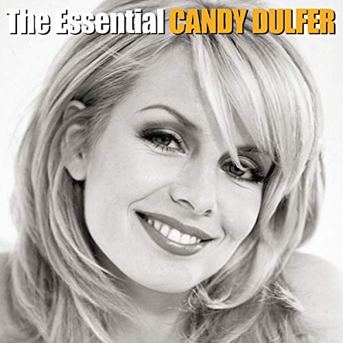 Close-up portrait of Candy Dulfer with blonde hair, smiling gently.