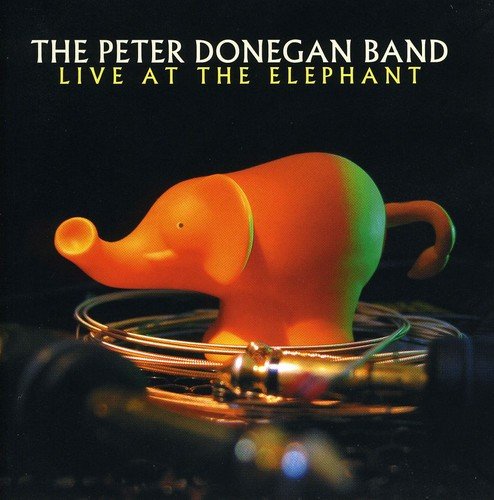 CD cover: orange plastic elephant on a turntable, dark background.