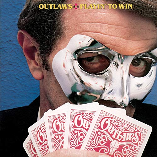 CD cover: man in a silver mask holding playing cards.