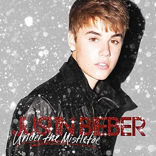 Justin Bieber album cover, "Under The Mistletoe," with falling snow effect.