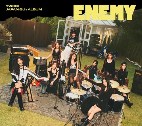 Nine women of TWICE pose with musical instruments in a garden.