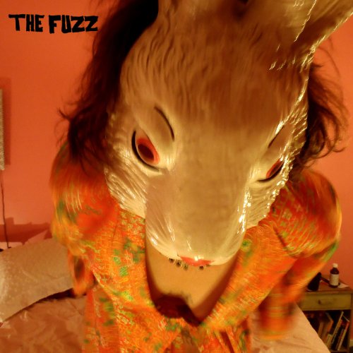 CD cover featuring a person wearing a realistic animal mask.