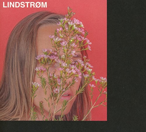 CD cover: face partially obscured by pink wildflowers on red background.
